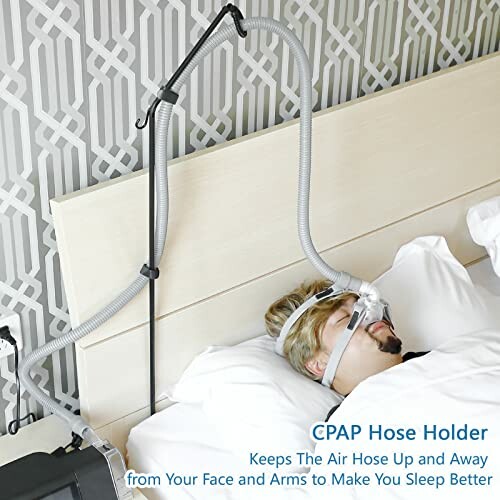 Person using CPAP hose holder while sleeping in bed.