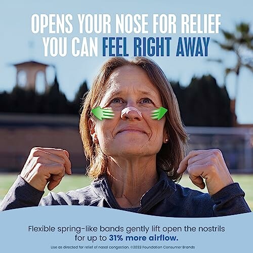 Person demonstrating nasal relief product outdoors.